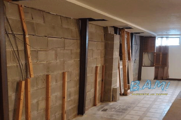 Bowing basement wall repaired with carbon fiber straps — BAM Basements & Masons Iowa